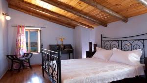 a bedroom with a black bed and a desk at Theasis Villas in Lygia +40 photos
