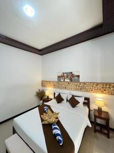 a bedroom with a bed and a table with pillows at Penida Dream Homestay and hostel in Nusa Penida