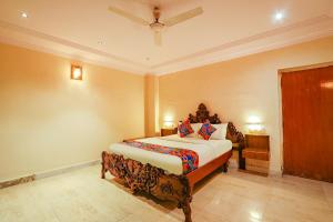 a bedroom with a bed and a ceiling at FabHotel Maruthi Residency in Hyderabad