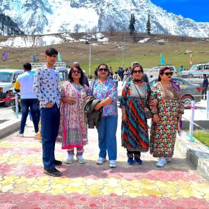 a group of people standing in front of a mountain at The relax in hotel in Katra