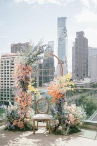 a chair sitting on top of a balcony with flowers at Eastin Grand Hotel Sathorn in Bangkok