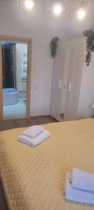 a bedroom with a bed with two towels on it at Casa Maria Sarata Monteoru in Sărata-Monteoru +75 photos