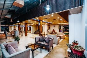 a lobby with couches and chairs and a table at Green Valley Resort Mashobra By AN Hotels in Shimla