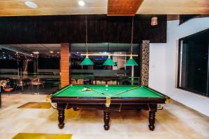 a pool table in the middle of a room at Green Valley Resort Mashobra By AN Hotels in Shimla