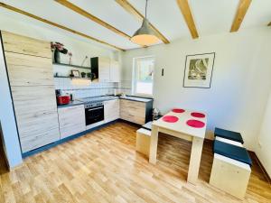 a kitchen with a table and a stove and a counter at Ferienhaus Stoertebeker in Warnemünde