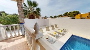a villa with a swimming pool and a balcony at Villa Greenland-A Murcia Holiday Rentals Property in Los Alcázares