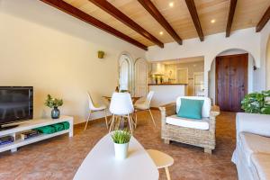 a living room with a couch and a tv at Finca Es Recer - ETV/1.751 in Santanyi