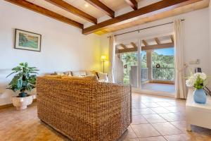 a living room with a couch and a large window at Finca Es Recer - ETV/1.751 in Santanyi