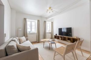 a living room with a couch and a tv at Stylish Apartments in CPH City in Copenhagen