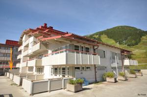 a large white building with potted plants in front of it at Åre Travel - Center in Åre