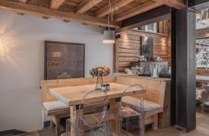 a dining room with a wooden table and chairs at Chalet Papillon - LES CHALETS COVAREL in Val dʼIsère