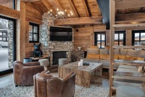 a living room filled with furniture and a fireplace at Chalet Papillon - LES CHALETS COVAREL in Val dʼIsère