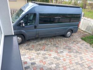 a blue van is parked in a driveway at Territory Parking RV&Campers Garden Forest park in Rīga