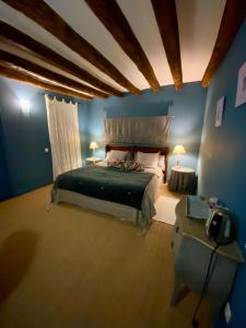 a bedroom with a bed in a blue room at La Maison de Philomène in Le Grand Entrevin