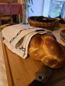 a loaf of bread sitting on a cutting board at Pensione Olanda in Locarno