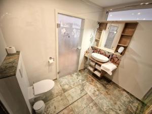 a bathroom with two sinks and a toilet and a mirror at Luxus mit Schwarzwaldromantik pur! in Ottenhöfen +20 photos