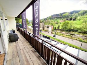 a balcony with a view of a road at Luxus mit Schwarzwaldromantik pur! in Ottenhöfen