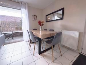 a dining room table with chairs and a mirror on the wall at TEA&CHILL- Oréo - 2 terraces - 10 min from metro in Bobigny