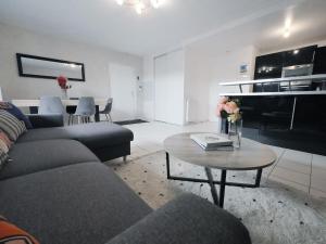 a living room with a couch and a table at TEA&CHILL- Oréo - 2 terraces - 10 min from metro in Bobigny