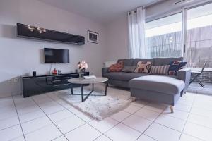 a living room with a couch and a table at TEA&CHILL- Oréo - 2 terraces - 10 min from metro in Bobigny