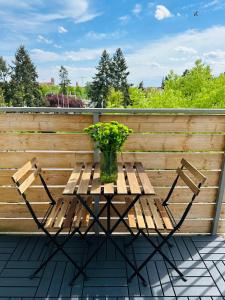 a wooden table with a vase of flowers on a patio at UNIQUE Apartment with parking in Toruń