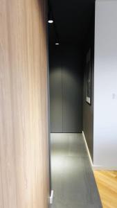 a hallway with a room with black walls and a door at UNIQUE Apartment with parking in Toruń