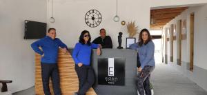 a group of people standing around a desk at Eden Resort Nubra in Hundar