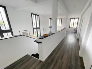 an empty room with white walls and windows at TEA&CHILL - Nice Triplex Loft - with garden in Montreuil