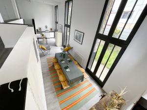 an overhead view of a living room with a table and chairs at TEA&CHILL - Nice Triplex Loft - with garden in Montreuil