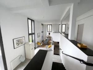 a living room with white walls and a white staircase at TEA&CHILL - Nice Triplex Loft - with garden in Montreuil