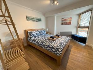 a bedroom with a bed and a ladder at Millgrove House Apartments in Eastbourne