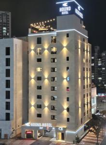 a hotel building with lights on top of it at Hound Hotel Mokpo Peace Plaza in Mokpo