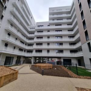a large white building with a courtyard in front of it at Flat Bobigny near Paris 1 min from the metro in Bobigny