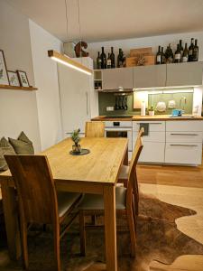 a kitchen with a wooden dining room table and chairs at Grünseeappartement in Turracher Hohe