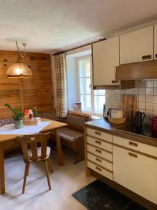 a kitchen with a table and a counter top at Farmhouse with a stunning view over the dolomites in Villnoss