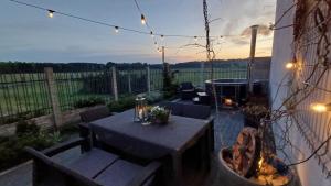 a patio with a table and a fire pit at Agroturystyka "Apartament na wsi" Bory Tucholskie in Szlachta