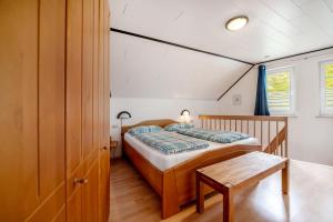 a bedroom with a bed and a table at Gästehaus Mühlenhof - Dornfelder in Maring-Noviand