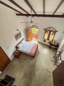 a bedroom with a bed and a wooden door at Light House View Inn - Galle Fort in Galle