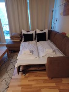 a large bed sitting on a couch in a living room at Ferienwohnung Wallner Rosi in Sankt Englmar