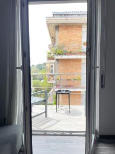 an open door to a balcony with a table at Bardolino Center Apartments in Bardolino