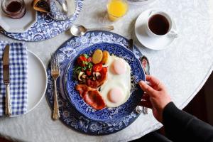 a person taking a picture of a plate of breakfast food at Fairview Historic Homestead in George