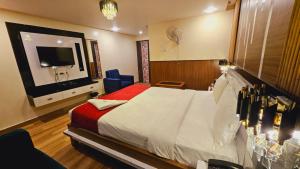 a hotel room with a bed and a television at HOTEL Bodhi Tree in Patna