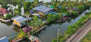 an aerial view of a house next to a river at Bell Farms and Resorts in Munroe Island