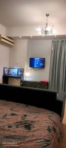 a bedroom with a bed and two monitors on the wall at 4 Season hotel in Lucknow