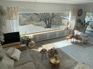 a living room with a couch and a large window at Relaxen am Wald in Stephanshausen in Stephanshausen