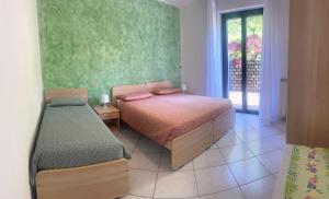 1 dormitorio con 2 camas y ventana en Hotel del Falco en Gravedona