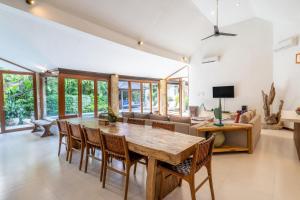 a dining room with a wooden table and chairs at Villa Aveli Seminyak by Best Deals Asia Hospitality in Seminyak