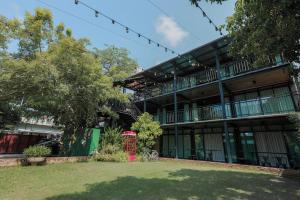 an office building with a lawn in front of it at Phuniphat Pool Villa in Nong Prue