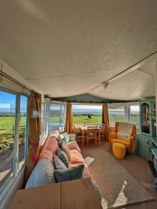 a living room with a couch and a table at Escape to the Mountain in Halkyn