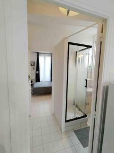 a hallway with a mirror and a bed in a room at Cozy Polo's House in Bagnolet